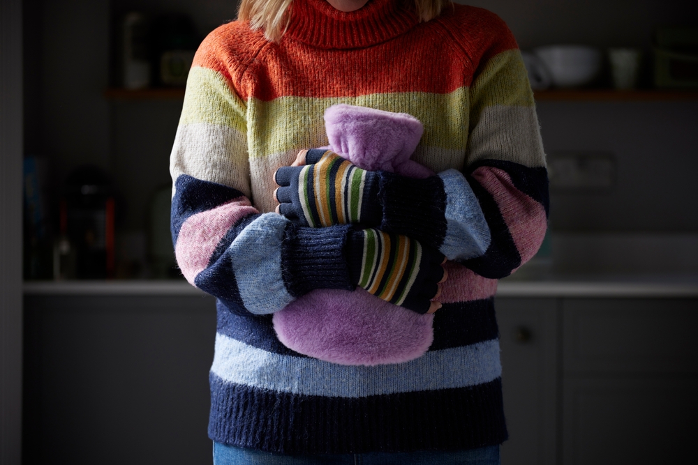 Woman hugging a hot water bottle,